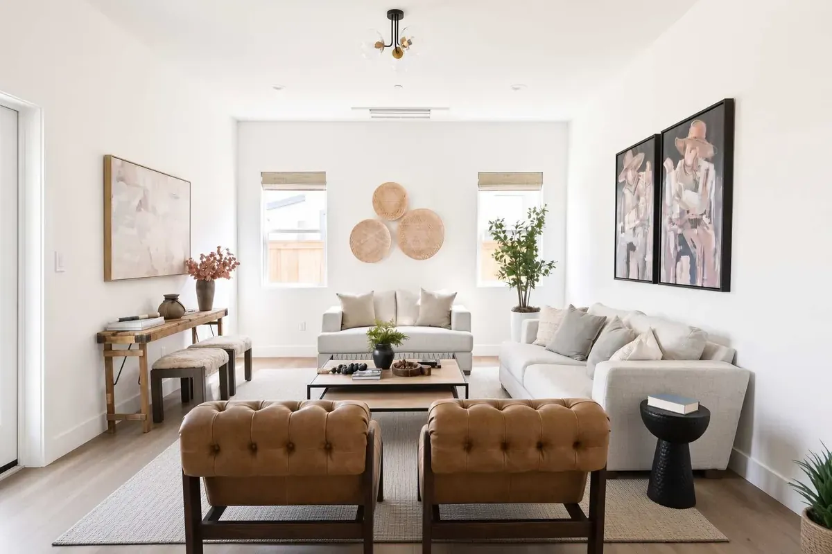 Bright great room with fireplace-side seating — listing photography by The Showing Studio
